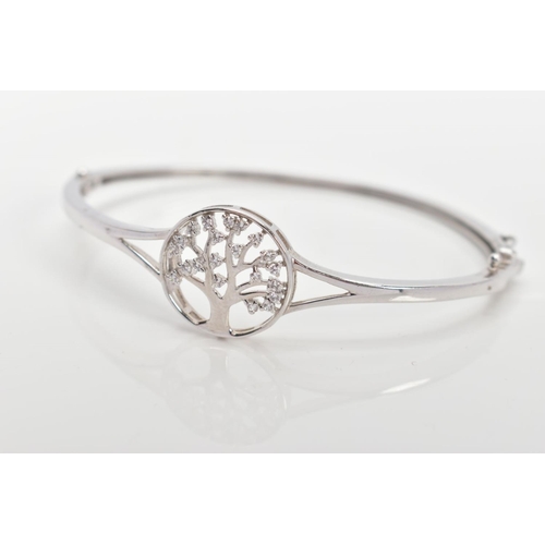 24 - A SILVER 'TREE OF LIFE' HINGED BANGLE, decorative openwork tree of life emblem set with colourless p... 