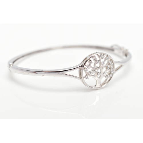 24 - A SILVER 'TREE OF LIFE' HINGED BANGLE, decorative openwork tree of life emblem set with colourless p... 