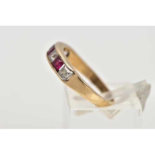 28 - A 9CT GOLD HALF ETERNITY RING, designed with a row of channel set square cut rubies interspaced with... 