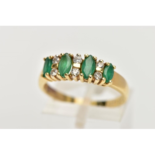 31 - A YELLOW METAL EMERALD AND DIAMOND HALF ETERNITY RING, designed with a row of four marquise cut emer... 