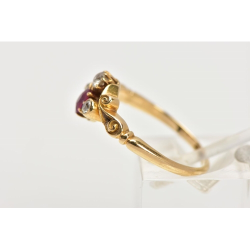 33 - A YELLOW METAL RUBY AND DIAMOND DRESS RING, designed with a cushion cut ruby, flanked with old cut d... 