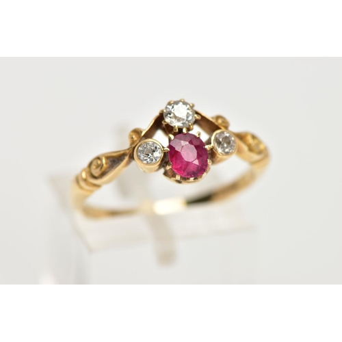 33 - A YELLOW METAL RUBY AND DIAMOND DRESS RING, designed with a cushion cut ruby, flanked with old cut d... 