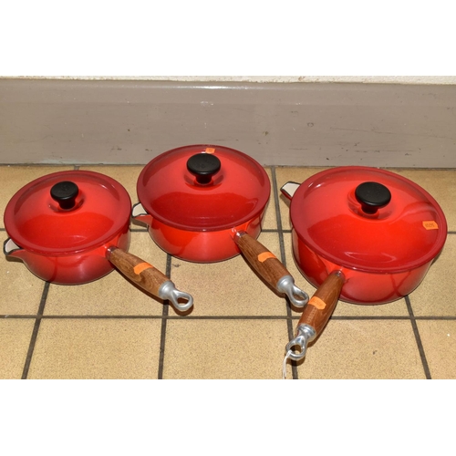 371 - A GRADUATED SET OF THREE LE CREUSET RED ENAMEL SAUCEPANS AND LIDS, wooden handles, diameters 16cm, 1... 