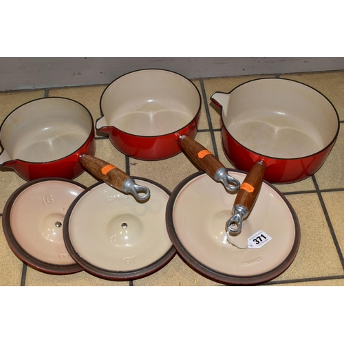 371 - A GRADUATED SET OF THREE LE CREUSET RED ENAMEL SAUCEPANS AND LIDS, wooden handles, diameters 16cm, 1... 