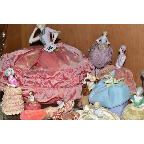 382 - A COLLECTION OF SIXTEEN LATE/EARLY 20TH CENTURY PORCELAIN HALF-DOLLS, including two dressing table b... 