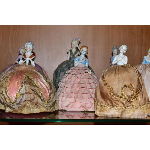 388 - ELEVEN LATE 19TH/EARLY 20TH CENTURY PORCELAIN HALF-DOLL TEA COSIES, PIN CUSHIONS, HAT PINS CUSHIONS,... 