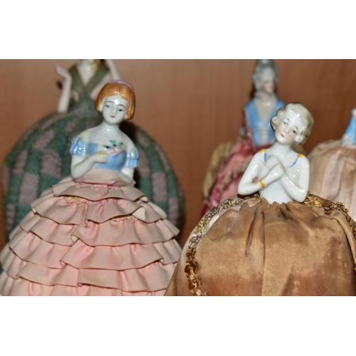 388 - ELEVEN LATE 19TH/EARLY 20TH CENTURY PORCELAIN HALF-DOLL TEA COSIES, PIN CUSHIONS, HAT PINS CUSHIONS,... 