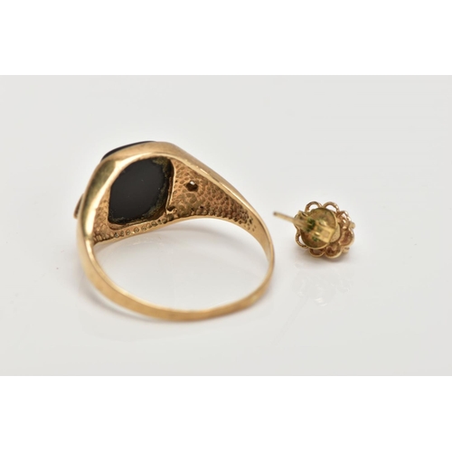 4 - A GENTS 9CT GOLD SIGNET RING, centring on a curved rectangular onyx panel, flanked with circular cut... 