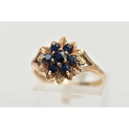 40 - A 9CT GOLD SAPPHIRE CLUSTER DRESS RING, of a flower shape, set with seven circular cut blue sapphire... 