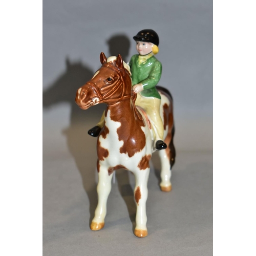 402 - A BESWICK GIRL ON PONY, No 1499, skewbald, Beswick crest backstamp, height 14cm (Condition:- paint r... 