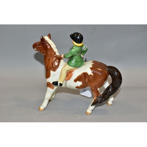 402 - A BESWICK GIRL ON PONY, No 1499, skewbald, Beswick crest backstamp, height 14cm (Condition:- paint r... 