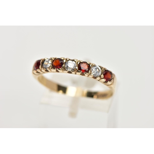 42 - A 9CT GOLD GARNET AND CUBIC ZIRCONIA HALF ETERNITY RING, designed with a row of four circular cut ga... 