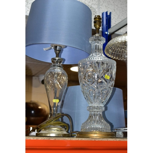 467 - THREE ELECTRIC LAMPS, comprising a cut glass urn shaped table lamp with blue shade, height approxima... 