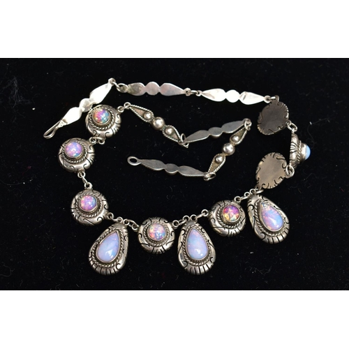 47 - A WHITE METAL AND FAUX OPAL CABOCHON NECKLET, designed with eight circular links each set with a fau... 