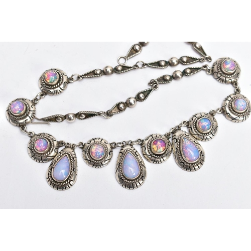 47 - A WHITE METAL AND FAUX OPAL CABOCHON NECKLET, designed with eight circular links each set with a fau... 