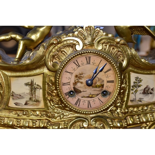 476 - A LATE 19TH CENTURY FRENCH STYLE GILT METAL MANTLE CLOCK, the hand painted dial has a river landscap... 