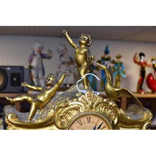 476 - A LATE 19TH CENTURY FRENCH STYLE GILT METAL MANTLE CLOCK, the hand painted dial has a river landscap... 