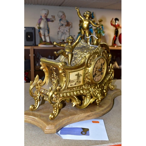 476 - A LATE 19TH CENTURY FRENCH STYLE GILT METAL MANTLE CLOCK, the hand painted dial has a river landscap... 