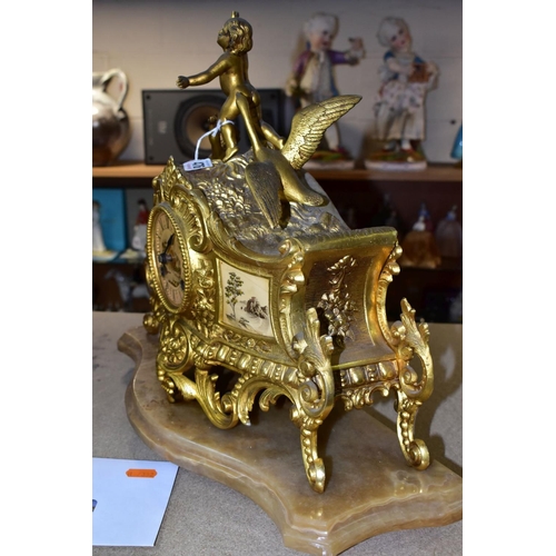 476 - A LATE 19TH CENTURY FRENCH STYLE GILT METAL MANTLE CLOCK, the hand painted dial has a river landscap... 