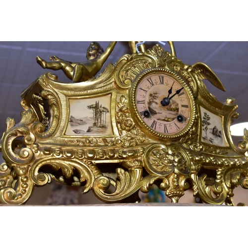 476 - A LATE 19TH CENTURY FRENCH STYLE GILT METAL MANTLE CLOCK, the hand painted dial has a river landscap... 