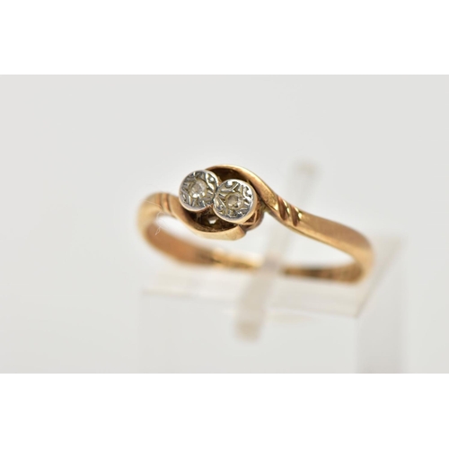 5 - A YELLOW METAL DIAMOND RING, designed with two illusion set, single cut diamonds, crossover shoulder... 