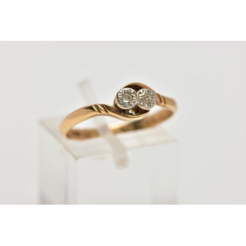 5 - A YELLOW METAL DIAMOND RING, designed with two illusion set, single cut diamonds, crossover shoulder... 