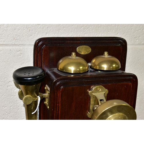 561 - A REPRODUCTION SIEMENS BROTHERS WALL MOUNTED TELEPHONE, wooden body with brass and bakelite fittings... 