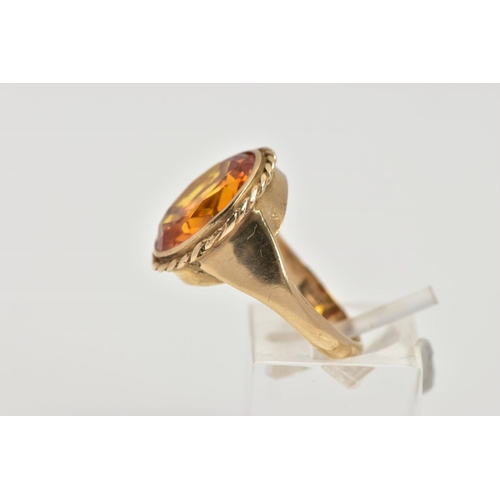 57 - A 9CT GOLD SYNTHETIC ORANGE SAPPHIRE DRESS RING, designed with a large oval cut synthetic orange sap... 