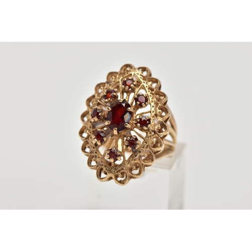 60 - A 9CT GOLD GARNET DRESS RING, of a large openwork marquise shape, set with circular cut garnets, ope... 