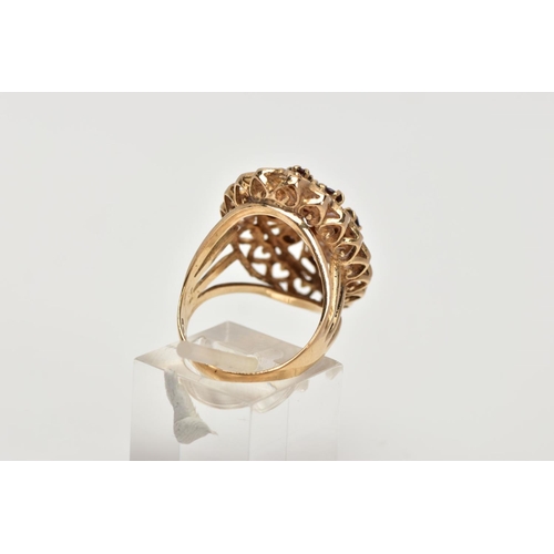 60 - A 9CT GOLD GARNET DRESS RING, of a large openwork marquise shape, set with circular cut garnets, ope... 