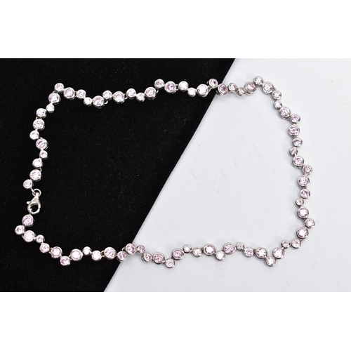 65 - A SILVER CUBIC ZIRCONIA NECKLET, the full chain set with alternating sizes of circular cut, pink cub... 