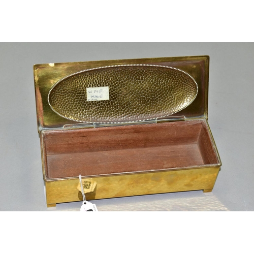 667 - A WMF BRASS AND WOOD CIGARETTE BOX, Circa 1910, the hinged lid has a planished, oval panel, the carc... 