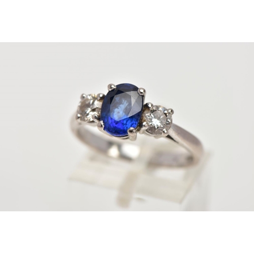 72 - AN 18CT WHITE GOLD SAPPHIRE AND DIAMOND RING, designed with a four-claw set, oval cut blue sapphire,... 