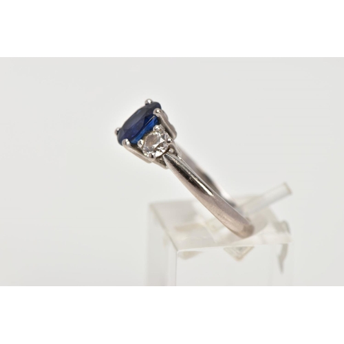 72 - AN 18CT WHITE GOLD SAPPHIRE AND DIAMOND RING, designed with a four-claw set, oval cut blue sapphire,... 