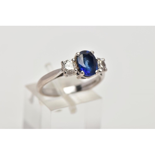 72 - AN 18CT WHITE GOLD SAPPHIRE AND DIAMOND RING, designed with a four-claw set, oval cut blue sapphire,... 