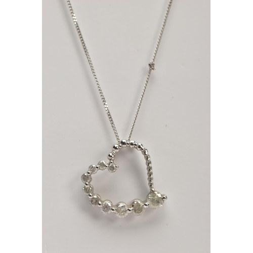 89 - A MODERN 9CT WHITE GOLD DIAMOND HEART AND CHAIN, a witch's graduated diamond heart pendant, estimate... 