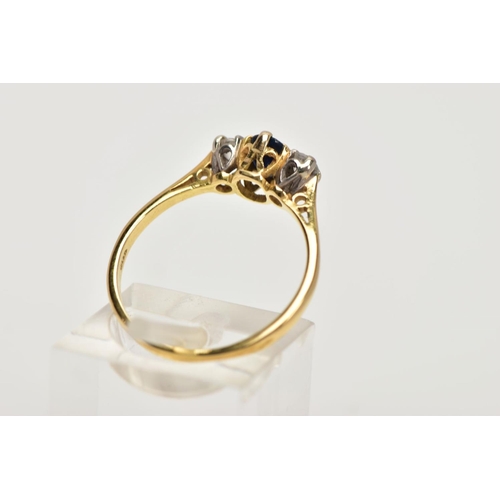 99 - AN 18CT GOLD SAPPHIRE AND DIAMOND THREE STONE RING, centring on a claw set, oval cut blue sapphire, ... 