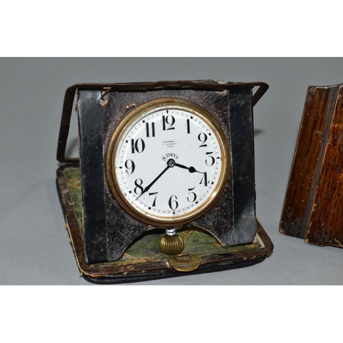 129 - AN EARLY 20TH CENTURY ASPREY 8 DAY TRAVEL CLOCK, in a damaged leather folding case, incomplete, toge... 