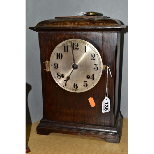 130 - AN EARLY 20TH CENTURY OAK CASED MANTEL CLOCK, the caddy style top above a silvered dial with Arabic ... 