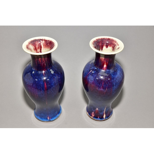 142 - A PAIR OF BALUSTER VASES covered in high fired Ruskin style glazes, unmarked, approximate height 24c... 