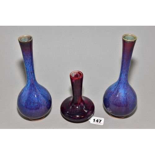 147 - A PAIR OF PEAR SHAPED VASES WITH ELONGATED TAPERING NECKS, streaked and mottled glazes, unmarked, ap... 