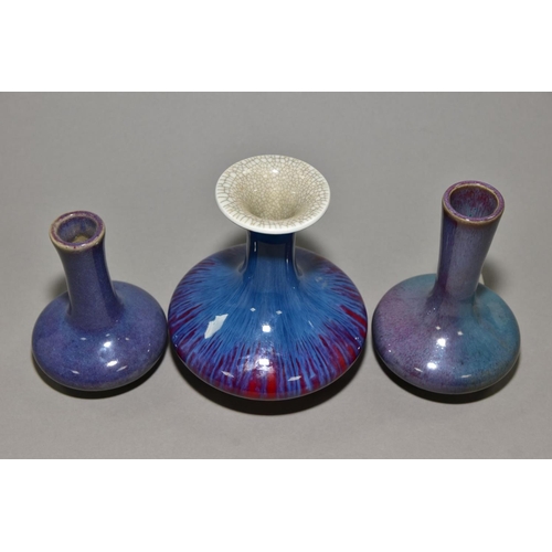 148 - THREE COMPRESSED PEAR SHAPED VASES, one having a flared rim with crackle glaze, red and purple strea... 