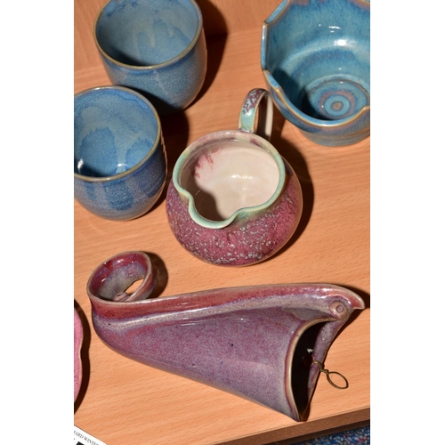 154 - EIGHT PIECES OF STUDIO POTTERY, comprising a tea cup and saucer, matching milk jug, wall pocket, bow... 