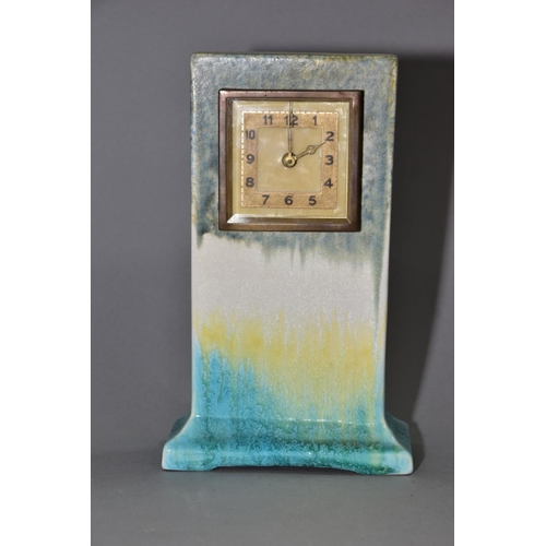 192 - RUSKIN POTTERY, a rectangular clock case with flared base, matt green fading to white and yellow, cr... 