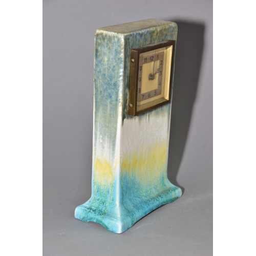 192 - RUSKIN POTTERY, a rectangular clock case with flared base, matt green fading to white and yellow, cr... 