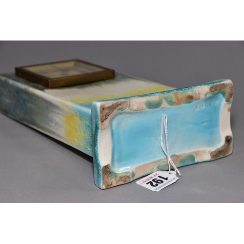 192 - RUSKIN POTTERY, a rectangular clock case with flared base, matt green fading to white and yellow, cr... 