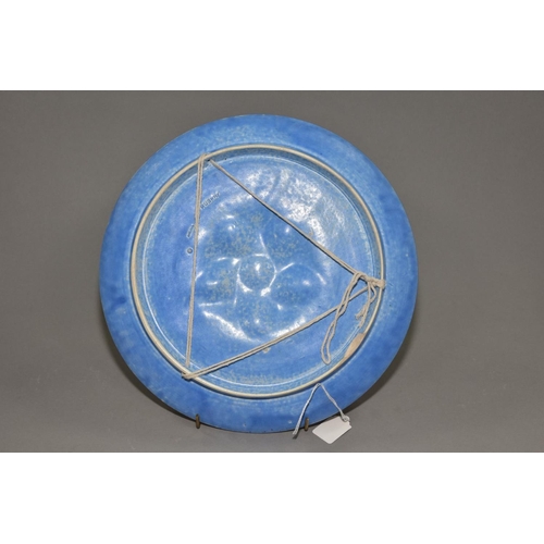 198 - RUSKIN POTTERY, a circular wall plaque/plate, having a central embossed section, the whole covered w... 