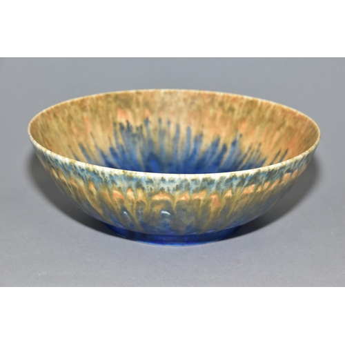 199 - RUSKIN POTTERY, a footed bowl covered in orange, green and blue glazes, impressed Ruskin England 193... 