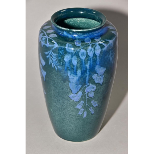 204 - RUSKIN POTTERY, 261 shape vase of high shoulder form, having a dark green mottled glaze with blue un... 