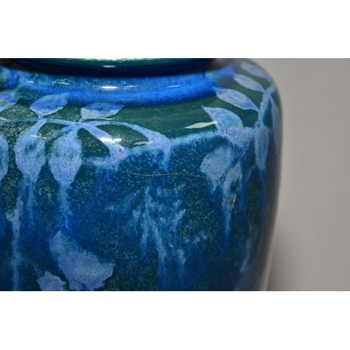 204 - RUSKIN POTTERY, 261 shape vase of high shoulder form, having a dark green mottled glaze with blue un... 